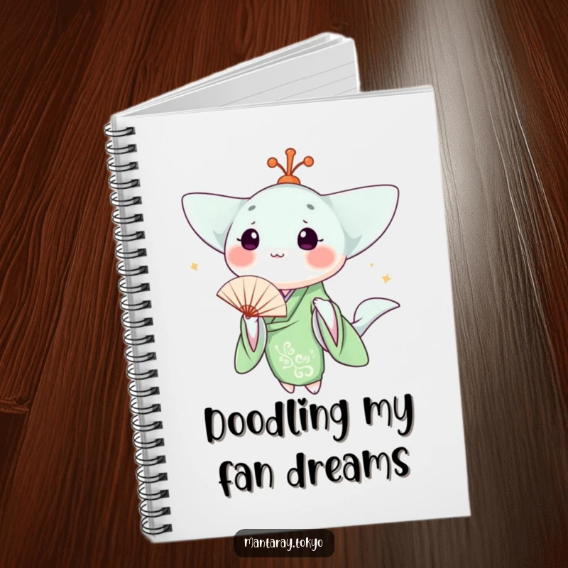 Funny kawaii manta ray in a green kimono holding a fan, on the cover of a notebook for writing or drawing.